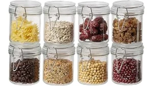 The image shows a collection of small, clear glass jars suitable for storing baby food.