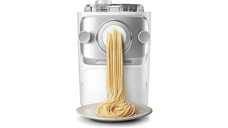 The image shows a shiny new pasta extruder machine with various pasta shapes neatly arranged.