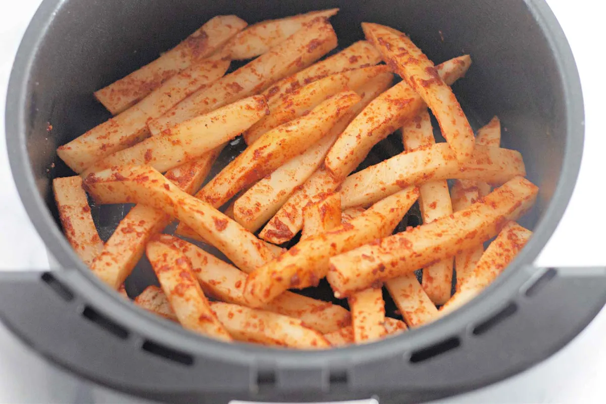 shaking air fryer basket seasoned fries