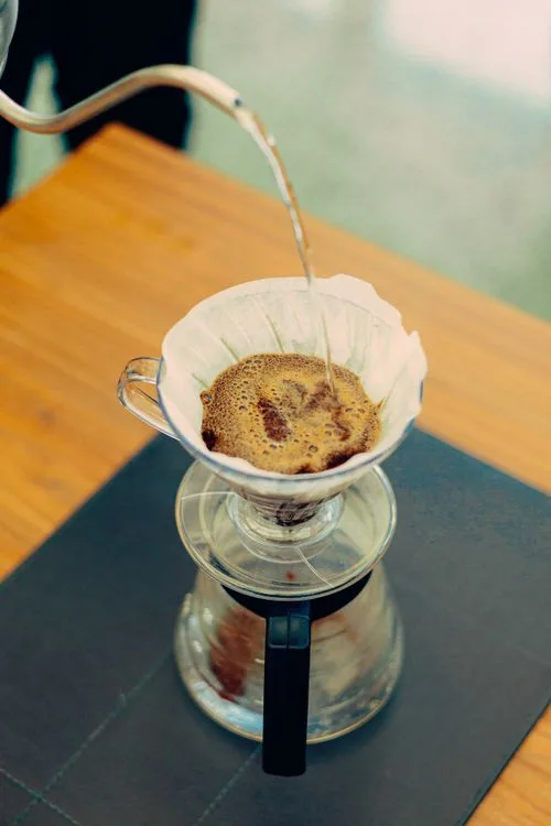 drip coffee maker pouring hot water into glass carafe