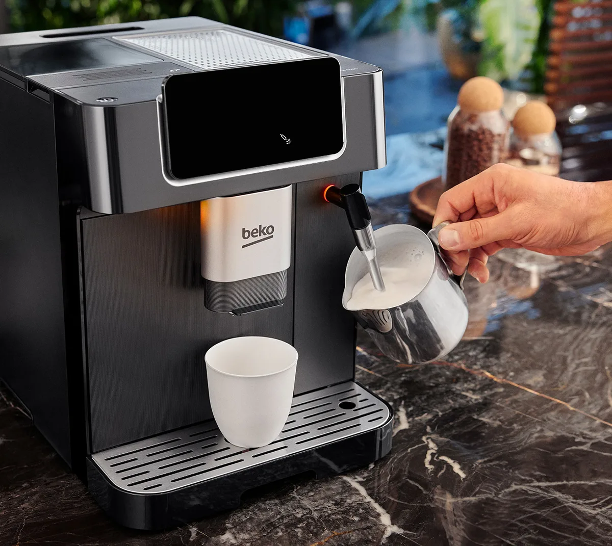 espresso machine steam wand dispensing hot water into cup