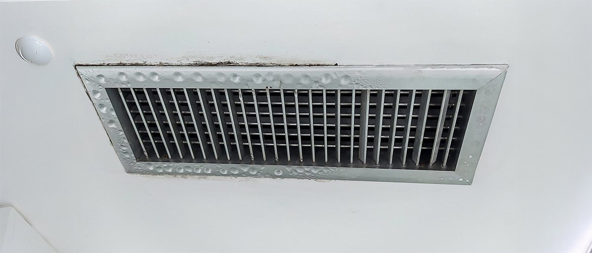 Condensation droplets forming on the interior metal ductwork of a kitchen range hood.